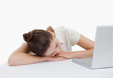 simsearch:400-05729275,k - Businesswoman leaning on her desk with a laptop against a white background Stock Photo - Budget Royalty-Free & Subscription, Code: 400-05900584