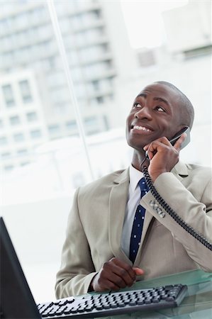 simsearch:859-06710917,k - Portrait of an office worker on the phone looking away from the camera Stock Photo - Budget Royalty-Free & Subscription, Code: 400-05900712
