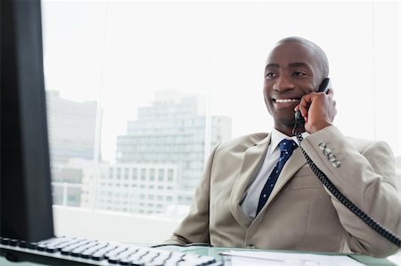 simsearch:859-06710917,k - Smiling businessman on the phone in his office Stock Photo - Budget Royalty-Free & Subscription, Code: 400-05900738