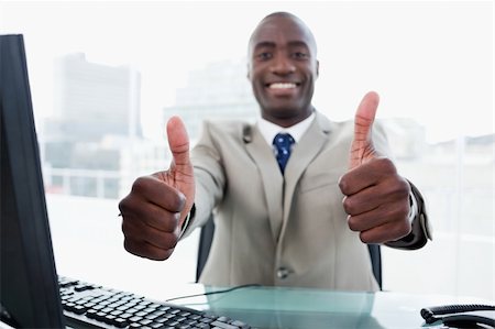 Entrepreneur working with a computer with the thumbs up in his office Stock Photo - Budget Royalty-Free & Subscription, Code: 400-05900756