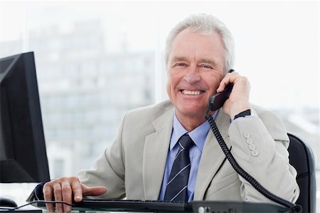 phone one person adult smile elderly - Smiling senior manager on the phone in his office Stock Photo - Budget Royalty-Free & Subscription, Code: 400-05900806