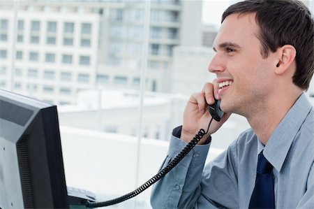 simsearch:400-05710264,k - Smiling office worker on the phone in his office Stock Photo - Budget Royalty-Free & Subscription, Code: 400-05900881