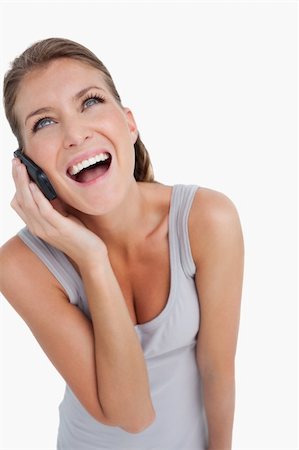 simsearch:400-05717420,k - Portrait of a laughing woman making a phone call against a white background Stock Photo - Budget Royalty-Free & Subscription, Code: 400-05901033