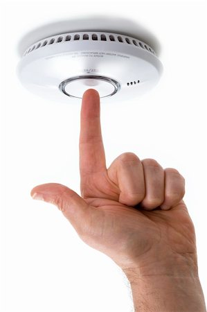 sensor - hand with pointing finger testing a domestic fire / smoke alarm detector  isolated on a white background Stock Photo - Budget Royalty-Free & Subscription, Code: 400-05902011