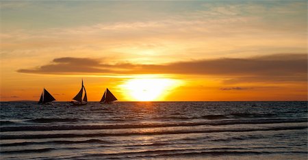 simsearch:400-05896461,k - silhouettes of sailing boats against a colorful sunset Stock Photo - Budget Royalty-Free & Subscription, Code: 400-05902742