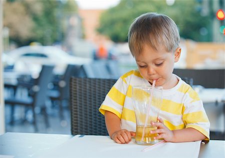 european style of coffee shop - Casual portrait of adorable little boy drinking juice in outdoor restaurant Stock Photo - Budget Royalty-Free & Subscription, Code: 400-05915240