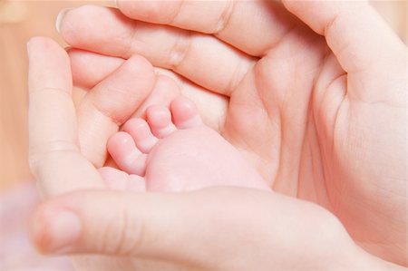 Small baby's foot in woman hands Stock Photo - Budget Royalty-Free & Subscription, Code: 400-05911560
