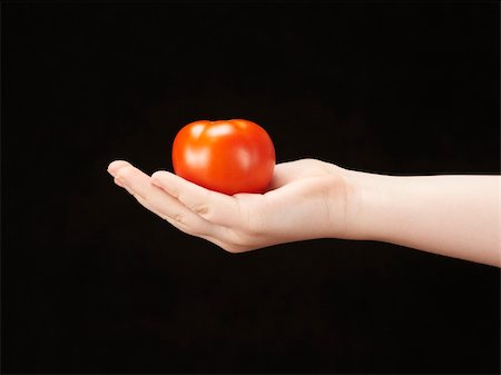 simsearch:400-04586134,k - Childs hand with tomatoe and palm facing up - on black background Stock Photo - Budget Royalty-Free & Subscription, Code: 400-05920020