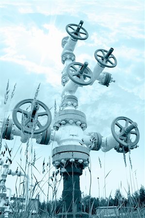 Oil industry. Wellhead with valve armature on a sky background. Toned. Stock Photo - Budget Royalty-Free & Subscription, Code: 400-06065896