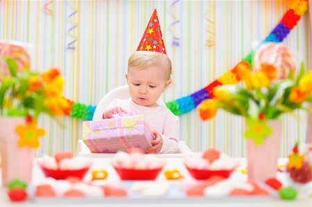 first birthday baby - Surprised baby looking on present on first birthday Stock Photo - Budget Royalty-Free & Subscription, Code: 400-06067051