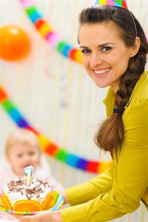 first birthday baby - Mom carries birthday cake to baby Stock Photo - Budget Royalty-Free & Subscription, Code: 400-06067065