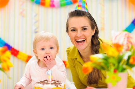 Portrait of mother with baby eating birthday cake Stock Photo - Budget Royalty-Free & Subscription, Code: 400-06067067