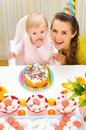 Portrait of happy mom and baby with birthday cake Stock Photo - Budget Royalty-Free & Subscription, Code: 400-06067070