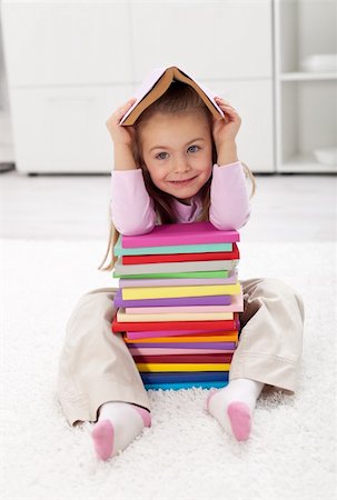 Little girl with lots of books having fun Stock Photo - Budget Royalty-Free & Subscription, Code: 400-06068483