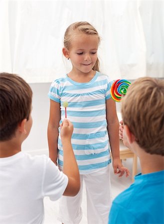 Boys courting a little girl with lollipops Stock Photo - Budget Royalty-Free & Subscription, Code: 400-06068533