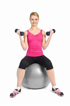 young woman posing with dumbbells sitting on fitness ball, on white background Stock Photo - Budget Royalty-Free & Subscription, Code: 400-06068894