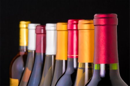 simsearch:400-04226436,k - Wine bottle necks with limited depth of field on black Stock Photo - Budget Royalty-Free & Subscription, Code: 400-06061252