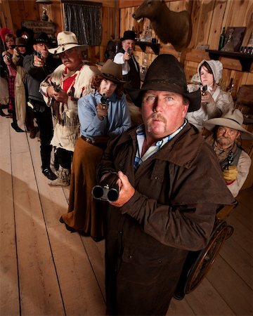 The entire saloon points their guns at an unseen danger. Stock Photo - Budget Royalty-Free & Subscription, Code: 400-06061743