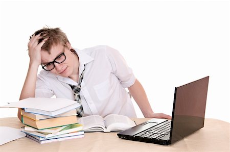 simsearch:400-04704759,k - frustrated student sits behind a desk isolated on white background Stock Photo - Budget Royalty-Free & Subscription, Code: 400-06063562