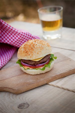 simsearch:400-06090558,k - Delicious hamburger in rustic setting. Burger on wooden board with beer Stock Photo - Budget Royalty-Free & Subscription, Code: 400-06075826