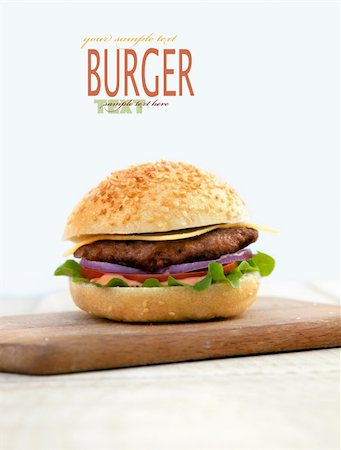 simsearch:400-06090558,k - Delicious hamburger isolated on white with copyspace. Burger on wooden board Stock Photo - Budget Royalty-Free & Subscription, Code: 400-06075827