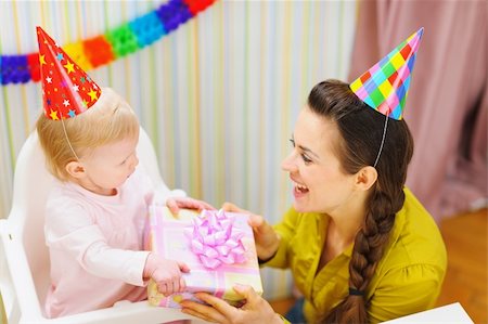Mother giving birthday gift for baby Stock Photo - Budget Royalty-Free & Subscription, Code: 400-06076006