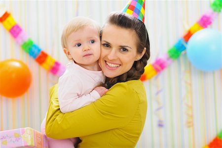 Portrait of happy mother and baby at birthday party Stock Photo - Budget Royalty-Free & Subscription, Code: 400-06076012