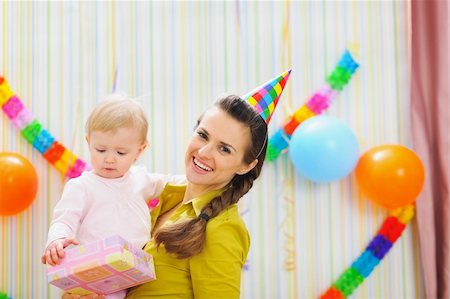 Portrait of happy mom and baby with birthday gift Stock Photo - Budget Royalty-Free & Subscription, Code: 400-06076013