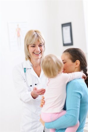 Senior pediatric doctor talking with mother and baby Stock Photo - Budget Royalty-Free & Subscription, Code: 400-06076051