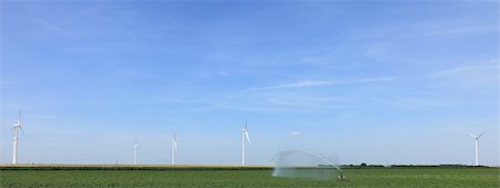 simsearch:400-05319608,k - Image of wind turbines and water sprinkler in a green field. Stock Photo - Budget Royalty-Free & Subscription, Code: 400-06076808