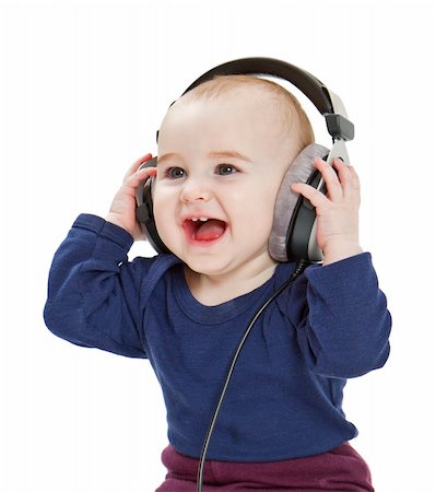 young, happy child with earphones listening to music. isolated on white background Stock Photo - Budget Royalty-Free & Subscription, Code: 400-06077870