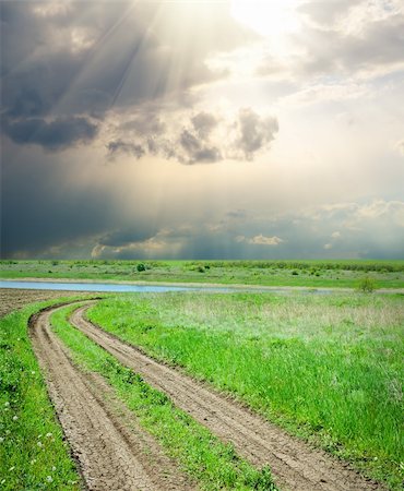 steppe - rural road in green grass under dramatic sky Stock Photo - Budget Royalty-Free & Subscription, Code: 400-06078254