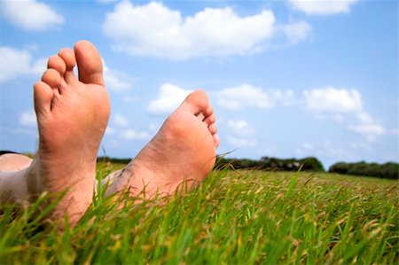 sleeping man foot - relaxed foot on grass with cloud background Stock Photo - Budget Royalty-Free & Subscription, Code: 400-06078479