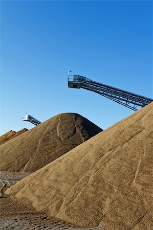 Conveyors and gravel heap at an industrial Plant for mining of basic materials Stock Photo - Budget Royalty-Free & Subscription, Code: 400-06078894