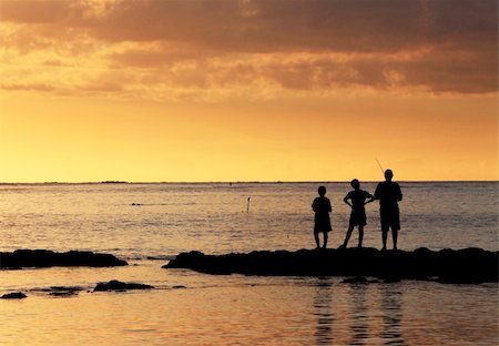 simsearch:400-06408905,k - Three young fishermen are on the beach at sunset. Stock Photo - Budget Royalty-Free & Subscription, Code: 400-06071072