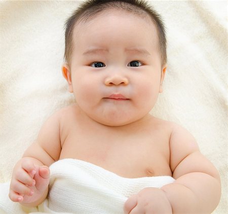 Asian baby boy lying on bed Stock Photo - Budget Royalty-Free & Subscription, Code: 400-06087219
