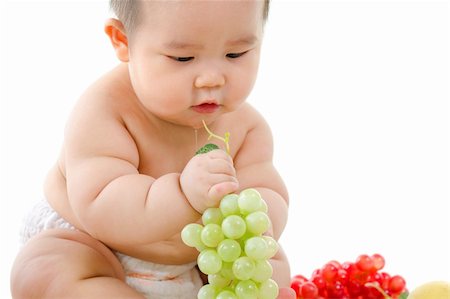 simsearch:400-07171482,k - Pan Asian Vegetarian baby playing with fruits on white background Stock Photo - Budget Royalty-Free & Subscription, Code: 400-06087221
