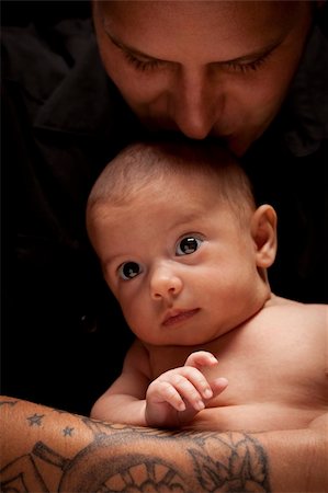 Happy Young Father Holding His Mixed Race Newborn Baby Under Dramatic Lighting. Stock Photo - Budget Royalty-Free & Subscription, Code: 400-06080072