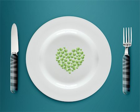 setting kitchen table - Heart shape green peas on white plate with knife and fork on blue background. Stock Photo - Budget Royalty-Free & Subscription, Code: 400-06080284