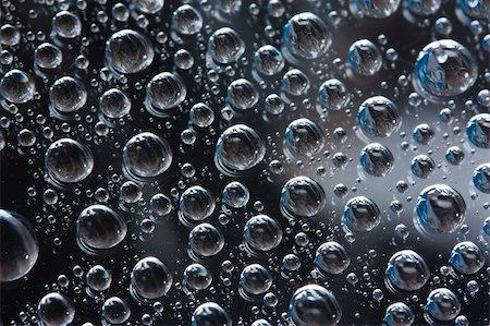simsearch:400-05363406,k - Close up of water drops on glass surface as background Stock Photo - Budget Royalty-Free & Subscription, Code: 400-06082163
