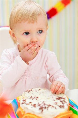 first birthday baby - Portrait of eat smeared kid eating cake Stock Photo - Budget Royalty-Free & Subscription, Code: 400-06083119