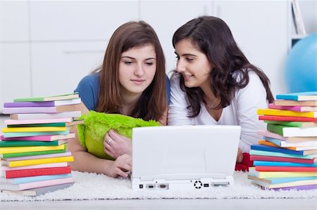 simsearch:400-05357982,k - Friends in college together - beautiful girls study with books and laptop, closeup Stock Photo - Budget Royalty-Free & Subscription, Code: 400-06083213