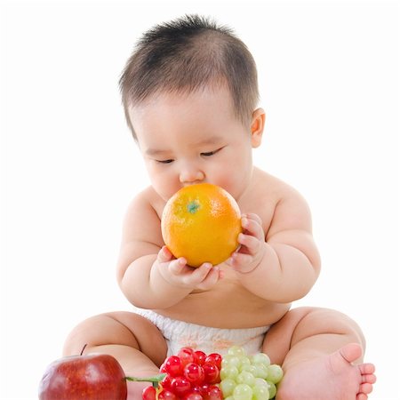 simsearch:400-07171482,k - Pan Asian Vegetarian baby playing with fruits on white background Stock Photo - Budget Royalty-Free & Subscription, Code: 400-06083644