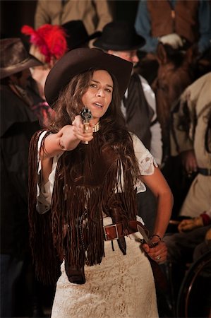 Sassy Latina woman in western outfit with pistol and dagger Stock Photo - Budget Royalty-Free & Subscription, Code: 400-06097062