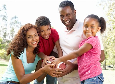 Family In Park With American Football Stock Photo - Budget Royalty-Free & Subscription, Code: 400-06097413