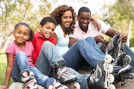 Family Putting On In Line Skates In Park Stock Photo - Budget Royalty-Free & Subscription, Code: 400-06097443