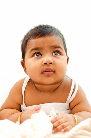6 months old Indian baby girl having thought, looking up Stock Photo - Budget Royalty-Free & Subscription, Code: 400-06098679