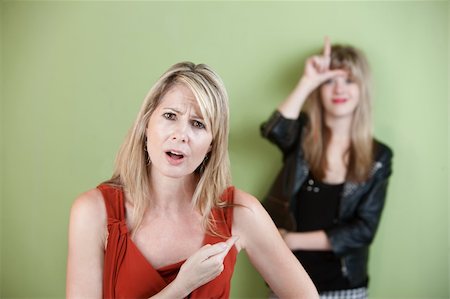 simsearch:400-05918419,k - Frustrated woman points at girl showing loser sign Stock Photo - Budget Royalty-Free & Subscription, Code: 400-06090237