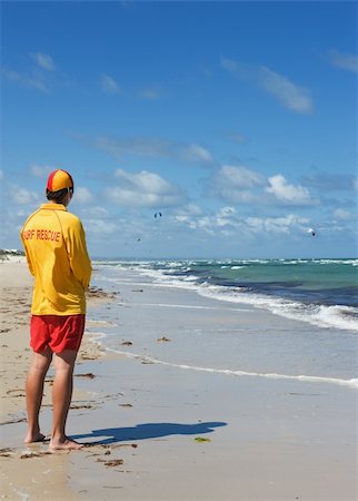 young man  life saver  watching the situation on the sea Stock Photo - Budget Royalty-Free & Subscription, Code: 400-06091588