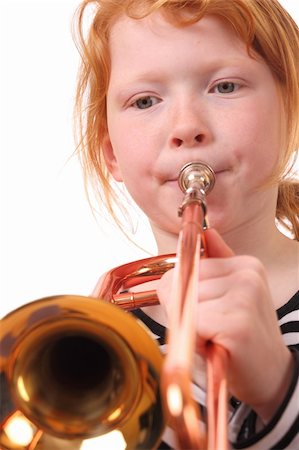simsearch:400-04863651,k - Young girl playing a trombone on white background Stock Photo - Budget Royalty-Free & Subscription, Code: 400-06092009